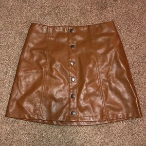 Small brown leather button up skirt.
